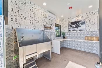 a bathroom with a sink and tiled walls